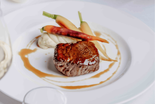 Seared steak with mashed potatoes and roasted carrots.